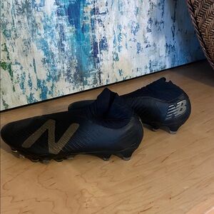 New Balance Black and Gold Athletic Cleats